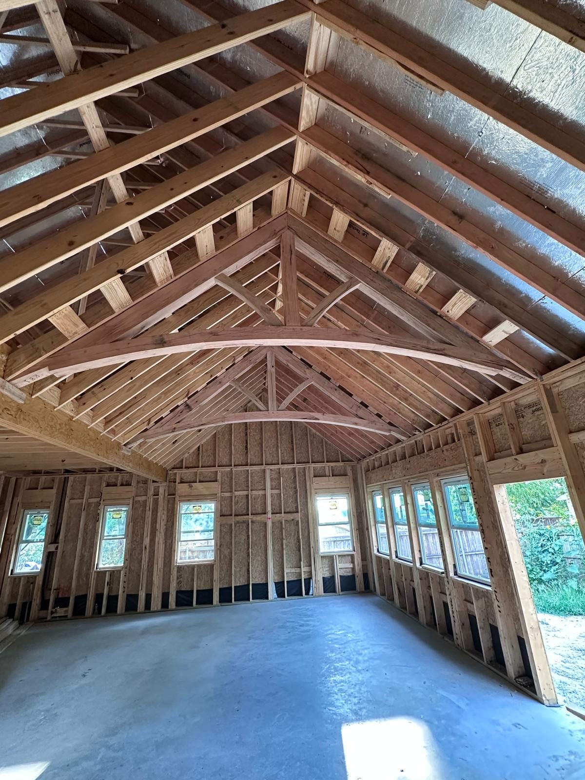 Exposed hand-built timber-truss cathedral ceiling framing