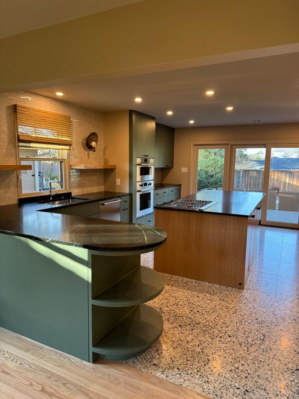 Sage-green cabinets in a finished kitchen